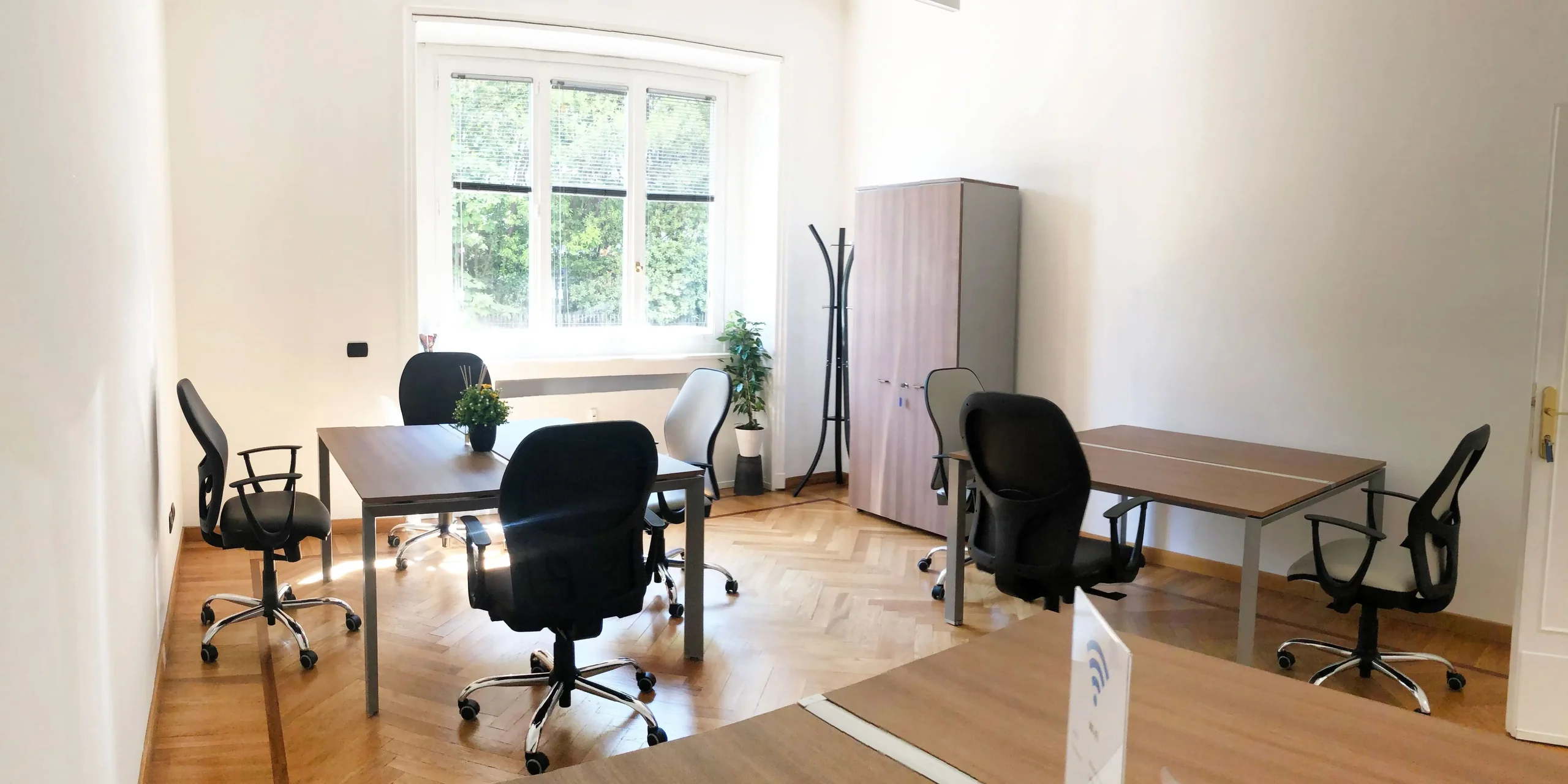 Private office with parquet and a garden window