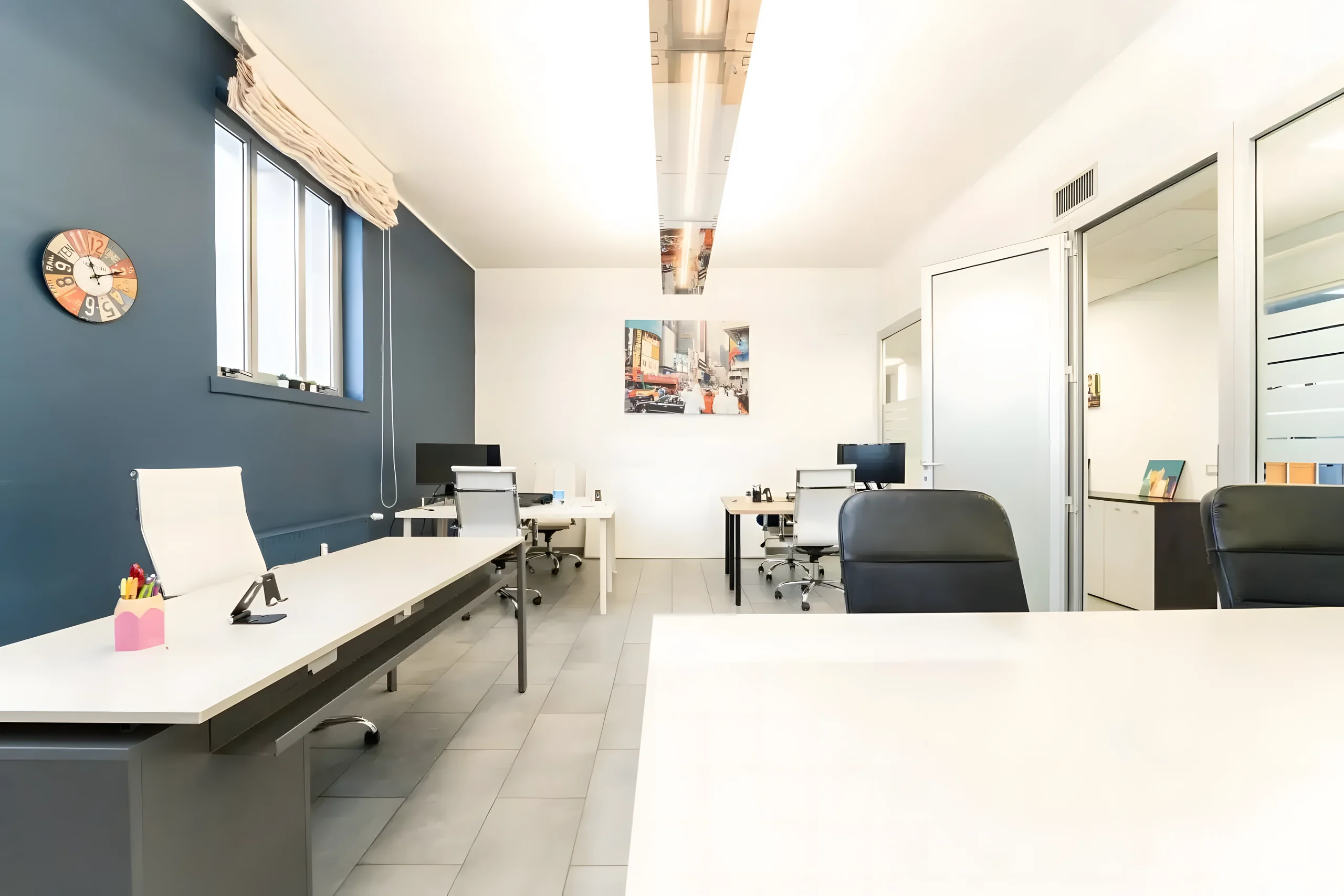 Private office with desks and glass partitions