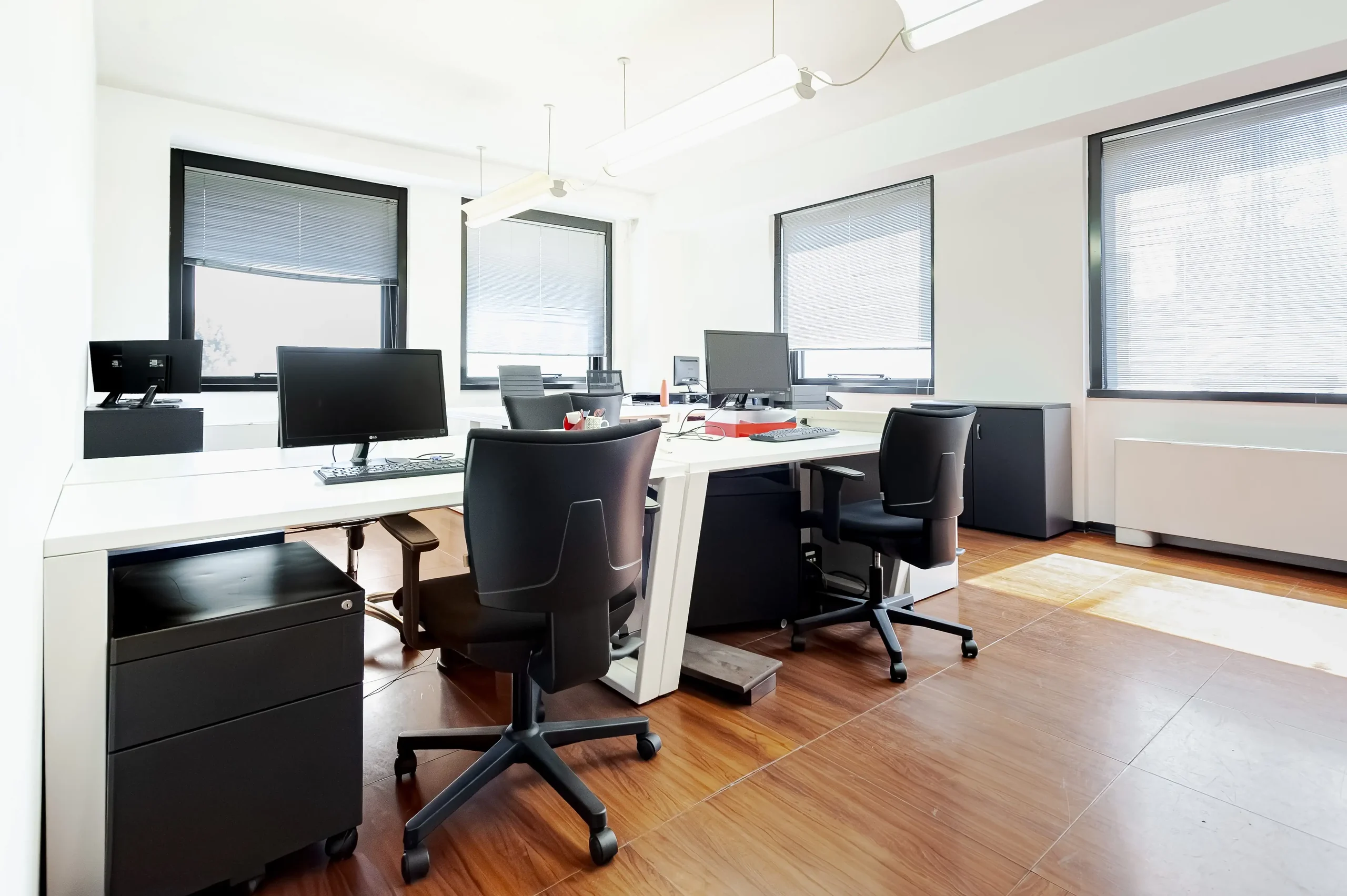 Private office with desks and large windows