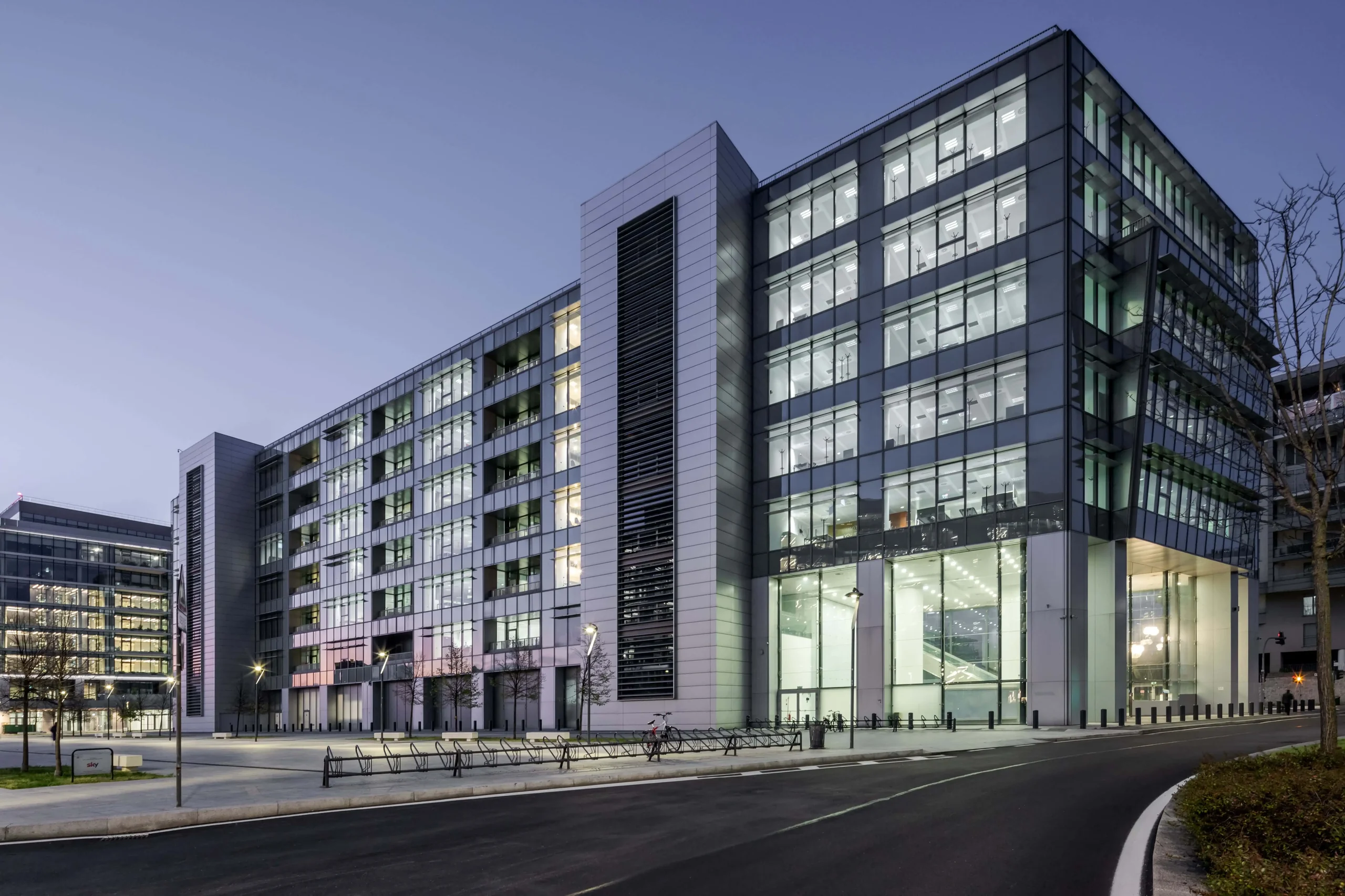 Glass-fronted office building at dusk