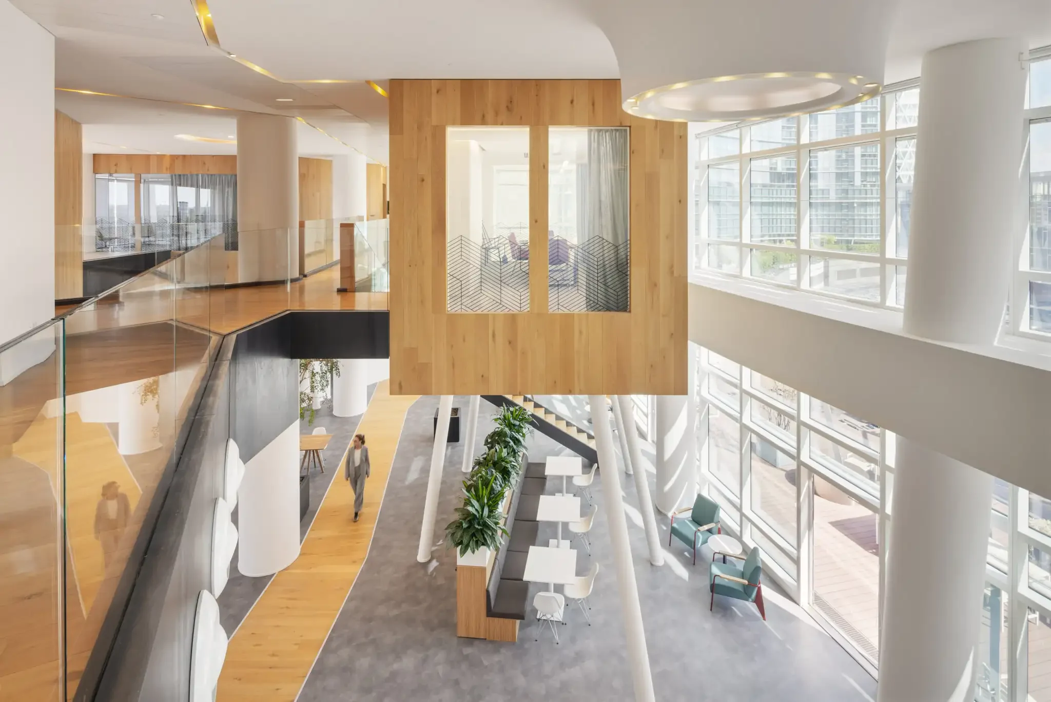 Multi-level atrium with glazing and timber volumes