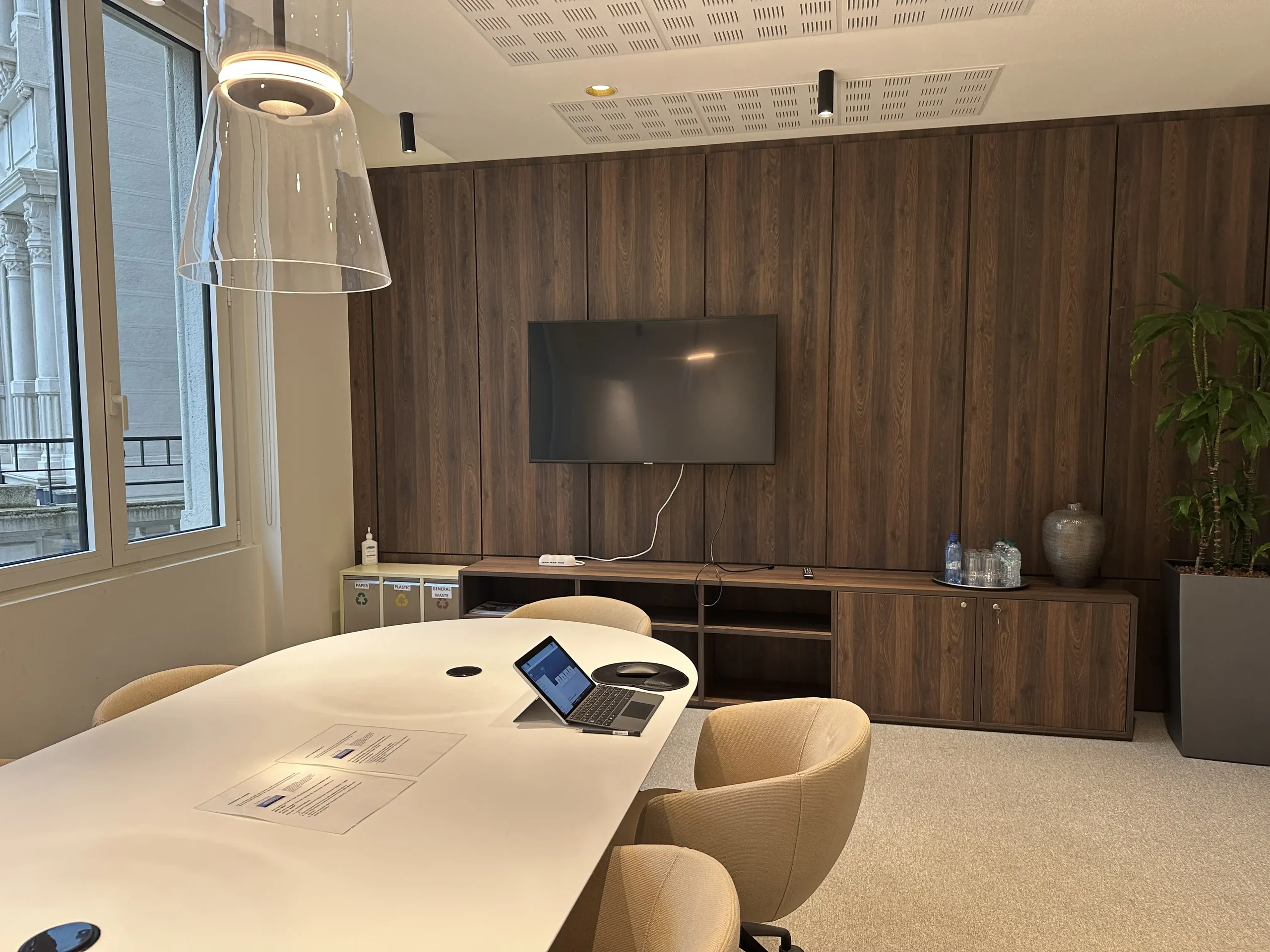 Meeting room with wood panelling and a screen
