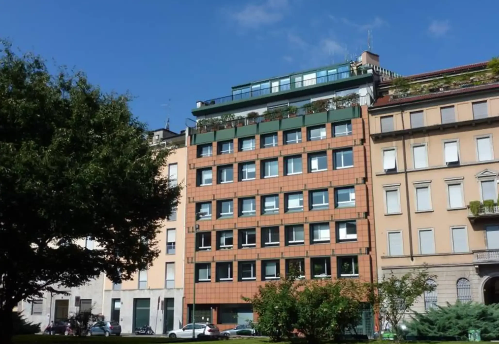 Building façade facing a tree-lined square