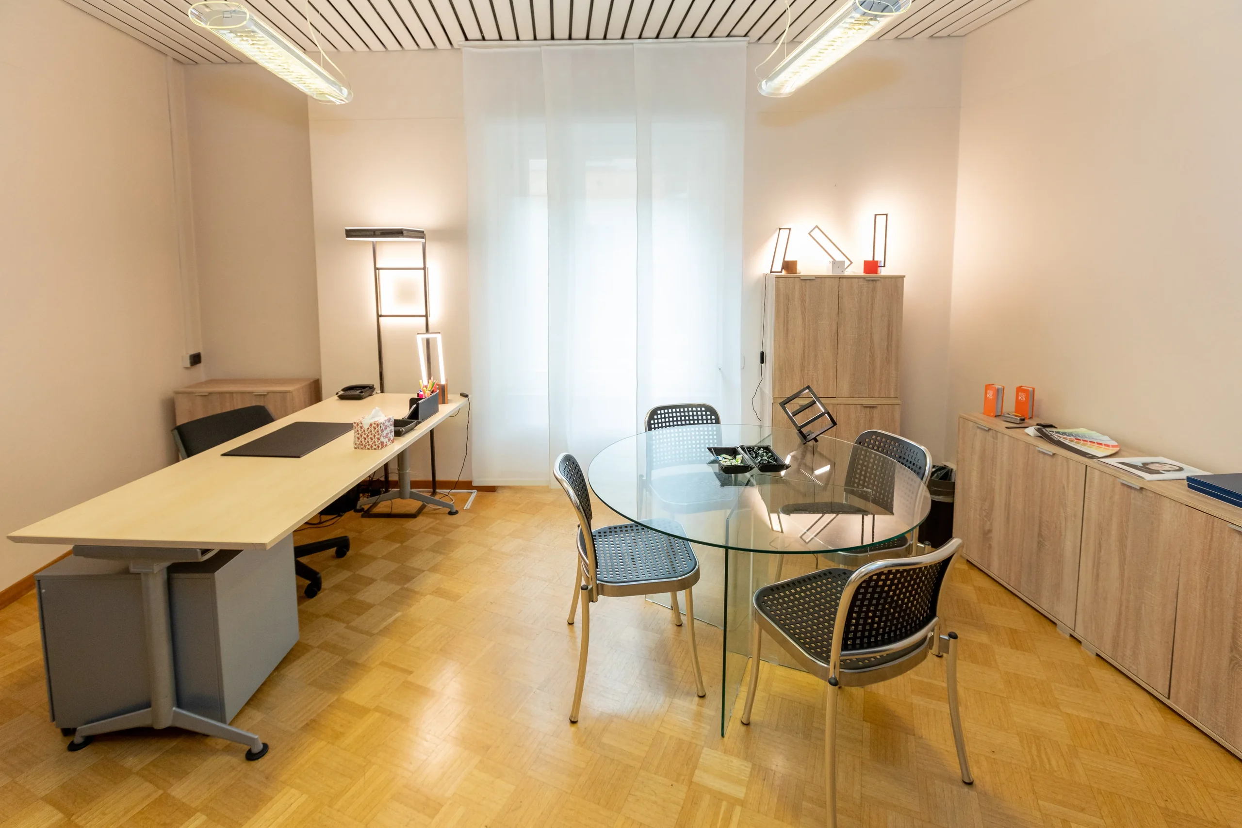 Private office with desk and round glass table